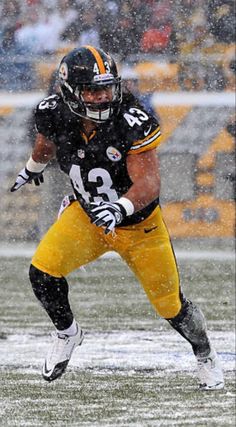 a football player is running in the snow