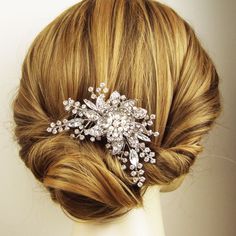 a woman's hair is shown with a crystal brooch on top of her head