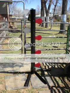 a gated in area with several red and white signs attached to it, on the grass