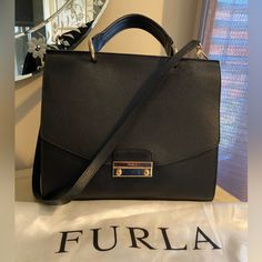 This Furla Bag Was Only Used Twice And Is In Nwot Condition. It’s Extremely Versatile And Looks Great With Corporate Or Casual Outfits! Besides Very Light Scratches On Front Clasp, It Is In Pristine Condition. Detachable Long Strap. 12in L X 10in H X 4.5in W Office Shoulder Bag With Branded Hardware, Top Handle Bags With Branded Hardware For Work, Office Bags With Branded Hardware And Top Handle, Workwear Rectangular Bags With Branded Hardware, Chic Bags With Detachable Handle And Flap, Rectangular Workwear Bag With Branded Hardware, Office Bag With Detachable Strap And Flap Shape, Office Satchel Flap Bag With Branded Hardware, Chic Flap Bags For Shopping