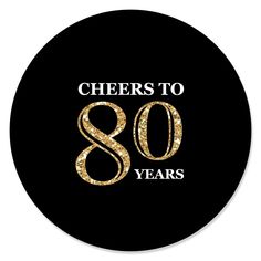 the logo for cheers to 80 years on a black circle with gold and white letters