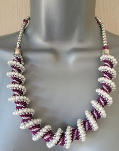 A stunning Cellini spiral rope statement necklace, made entirely from small white glass pearls, silver, white and a beautiful shade of dark fuchsia, combine with silver finishings, and Swarovski crystals, with a simple non-tarnish silver clasp. All strung on 6lb strength Fireline for durability. I absolutely loved making this necklace and I was very happy with the finished result, it also has a very pleasing weight to it, and looks far more expensive than it is.  Length is 22.5 inches / 58 cms a Elegant Beaded Spiral Jewelry, Handmade White Spiral Necklaces, Adjustable White Spiral Jewelry, White Adjustable Spiral Jewelry, Spiral White Jewelry For Wedding, Spiral Beaded Silver Jewelry, Silver Spiral Beaded Jewelry, Cellini Spiral, Beaded Jewelry Necklaces