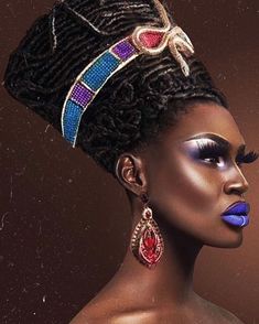 an african woman with blue and purple makeup looks into the distance as she stands in front of a brown background