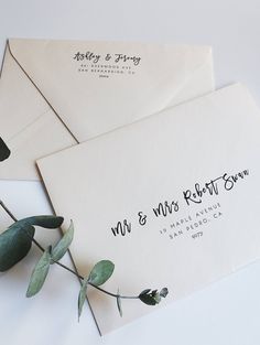 two wedding envelopes with the words mr and mrs written on them