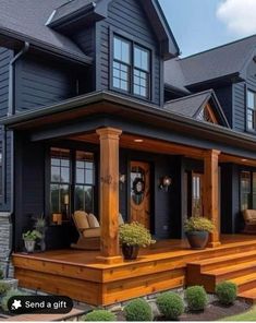 a large house with wooden steps leading up to it's front door and covered porch