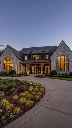 a large house with lots of windows and landscaping