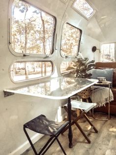 the inside of a camper with a table and chairs