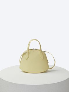 COURONNE is a modern luxury handbag brand that emphasizes simplicity, timeless chic, and exquisite color as its keywords. By pursuing a contemporary style and innovation, the brand provides a sense of confidence that does not fall behind trends. - Made of smooth and textured leather- Structured trapezoidal shape with curved bottom- Eye-catching stitching detail- Double leather top handles- Adjustable and detachable shoulder strap- Zipper closure at the opening- Casual and stylish mood Timeless Chic, Leather Top, Luxury Handbags, Womens Tote Bags, Modern Luxury, Contemporary Style, Shoulder Strap, Sense, Handles