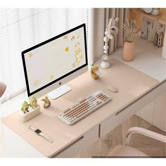 a computer monitor sitting on top of a wooden desk next to a keyboard and mouse