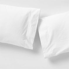 two white pillow cases sitting next to each other