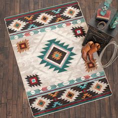 an area rug on the floor with cowboy boots and other items in front of it