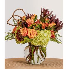 a vase filled with lots of flowers on top of a table