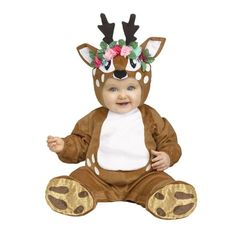 a baby wearing a deer costume sitting on the ground