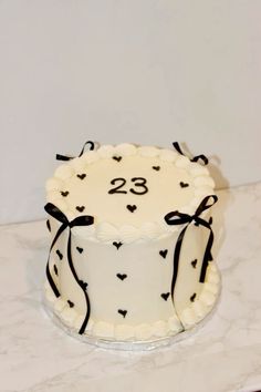 a decorated cake with the number twenty eight on it sitting on a countertop in front of a white wall