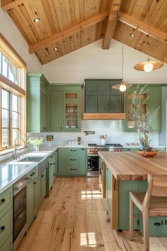 a large kitchen with green cabinets and wooden flooring on the ceiling, along with an island in the middle