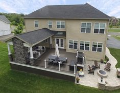 an aerial view of a house with patio and seating area