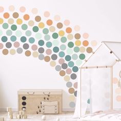 a room with polka dots on the wall next to a clock and other items in front of it