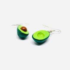 Inspired by the vibrant culture and art of Mexico, these Avocado Clay Earrings are a must-have for any fashion-forward individual. Hand-crafted by skilled artisans, each intricate design showcases the beauty of traditional Mexican jewels. Indulge in the delicious combination of mini realistic drops and dangle earrings that radiate natural charm and elegance. Perfect for summer fashion, these earrings are a unique and memorable gift that will be cherished and worn with pride. Gift-ready, these ea Unique Danglers As Gift, Single Plug Earring As Festival Gift, Artisan Teardrop Earrings As Gift, Artisan Teardrop Earrings For Pierced Ears As Gift, Traditional Hypoallergenic Drop Earrings, Artisan Green Jewelry, Teardrop Danglers For Gift, Unique Green Teardrop Earrings For Gift, Unique Teardrop Plug Earrings For Gift