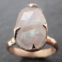 I created this setting in wax then cast it in recycled solid 14k gold at my home studio. This ring is a size 7 it can be resized up or down. The stone is rainbow moonstone. it measures about 15mm X 9mm I created a rustic texture in the gold. Throughout all time and history, in every tribe and culture all around the world crystals, minerals and gemstones have used for healing, luck, divination, adornment vibrational medicine and so much more. A stone for new beginnings, Moonstone is a stone of in Unique Moonstone Wedding Ring With Large Stone, Vibrational Medicine, Rustic Texture, Minerals And Gemstones, Soft Natural, Ring Gemstone, Crystals Minerals, Rainbow Moonstone, Yellow Gold Rings