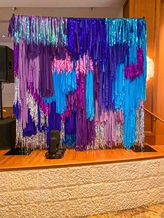 there are many streamers hanging on the wall in front of a speaker and speakers