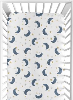 a white crib with stars and crescents on it, in front of a white background