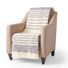 a chair with a blanket on top of it and a wooden frame around the arm