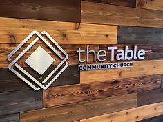 the table community church logo on wood wall