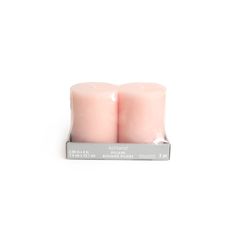 two pink candles sitting next to each other