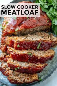 slow cooker meatloaf on a platter with parsley in the background