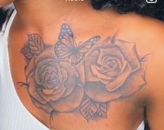 a woman with a butterfly on her back and some roses in front of her shoulder