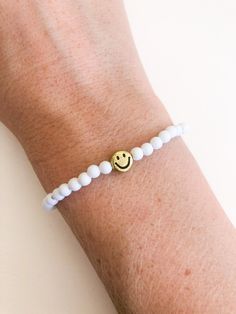 "customize your very own happy smiley face stretchy bracelet, made to order in your size! you will receive one white beaded bracelet with your choice of center smiley bead (gold or yellow). PLEASE NOTE: you will receive ONE bracelet with this order. these super trendy and versatile stretch bracelets are the perfect little accessory for your wrist. they are dainty and beautiful by themselves, but also look great when combined and stacked. you can add to your stack right here: http://www.etsy.com/ White Hypoallergenic Friendship Bracelets For Everyday, White Stretch Bracelet With Smiley Face For Gift, White Bracelets With Smiley Face For Gift, Casual White Friendship Bracelets With Smiley Face, Everyday White Bracelets With Smiley Face, White Smiley Face Bracelet As Gift, Playful White Friendship Bracelets With Smiley Face, Casual White Smiley Face Friendship Bracelets, White Playful Smiley Face Friendship Bracelets