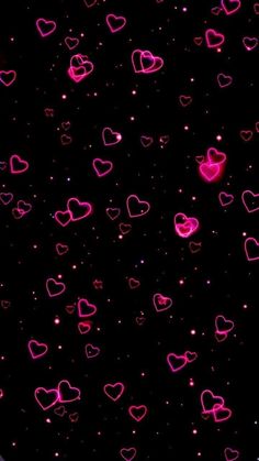 many pink hearts on a black background with stars and sparkles in the dark sky