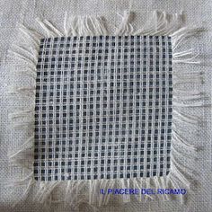 a piece of cloth with fringes on it