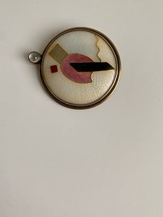 "Ginny Whitney Enamel Cloisonne Geometric Pin Brooch. Measures approximately 1 5/8\" x 1 7/16\". In very good previously owned vintage condition. Please view all photos as part of this description. I am always happy to respond to questions. Ginny Whitney's enamels, with their handstoned matte finish and careful composition, are studies in form and color. Modernism and Art Deco are strong influences in her work. Her current series of work uses intersecting geometric lines and circles, each one a distinct enamel composition, contrasting colors and forms." Mid-century Cabochon Brooch For Gift, Mid-century Cabochon Brooch Gift, Mid-century Cabochon Brooches For Gifts, Art Deco Enamel Round Jewelry, Art Deco Round Enamel Jewelry, Vintage Pendant Brooches With Cabochon, Vintage Enamel Jewelry With Large Pendant, Vintage White Pendant Brooches, Vintage Enamel Round Pendant Jewelry