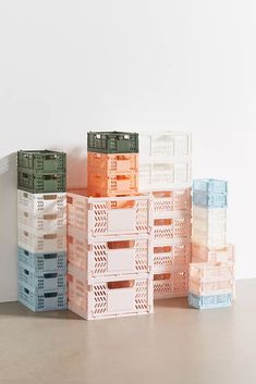 several crates stacked on top of each other in front of a white wall and floor