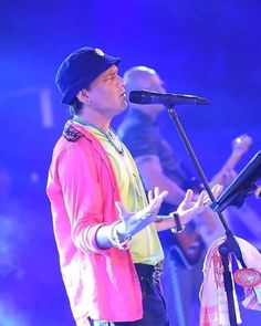 a man standing next to a microphone on top of a stage