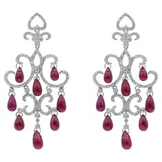 An intricately designed pair of chandelier earrings, showcasing 16 dangling pear shape cabochon rubies weighing 32.20 carats total. Accented by 328 round brilliant cut diamonds weighing 1.90 carats total. Finely made with 18K white gold. Perfect for luxurious events. Available in a matching necklace. Please inquire about item DN490/2. Luxury Ruby Teardrop Jewelry, Festive Ruby Chandelier Earrings, Exquisite Red Ruby Earrings, Luxury Ruby Earrings With Intricate Design, Luxury Ruby Chandelier Earrings, Diamond Chandelier, Diamond Chandelier Earrings, Platinum Rose Gold, Solitaire Pendant Necklace