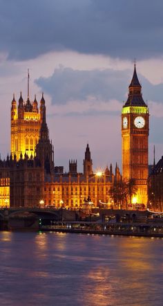 the big ben clock tower towering over the city of london, england at night time