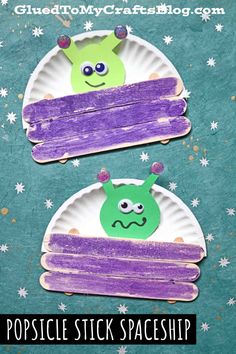 two paper plates with purple and green designs on them, one has an alien face