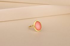 Our Coral Gemstone Women Ring in Gold and Silver is the perfect gift for your loved one. Coral has been used as jewelry for thousands of years, and for good reason: it's beautiful. It's also believed to have healing properties, which makes it the perfect gift for your mom, girlfriend, or wife. This ring has a simple and elegant design that will make you feel like royalty when you wear it. The oval stone is set in a beautiful gold band with a silver accent on top. The minimalist design allows this ring to go with any outfit while still standing out as something special and unique. Details of the product Material: 10K and 14K Solid Gold, Silver Gemstone: Coral Gemstone Gemstone Size: 12x16 mm Unique Gift For people whom you love; Mom, Girlfriend, Wife, Fiance, Best Friend; Dainty Gift Idea; Delicate Oval Rings For Gift, Delicate Oval Rings For Gifts, Fine Jewelry Oval Stackable Rings As Gift, Oval Stackable Rings For Gift, Minimalist Oval Rings For Gifts, Oval Minimalist Rings For Gifts, Minimalist Oval Rings As Gifts, Oval Birthstone Stackable Rings, Pink Oval Cabochon Rings For Gift