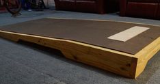 a wooden table sitting on top of a carpeted floor