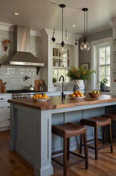 a kitchen island with stools in front of it and an oven on the other side