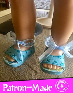 a close up of a doll's feet wearing sandals