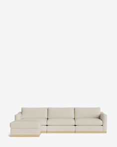 a white couch sitting on top of a wooden floor