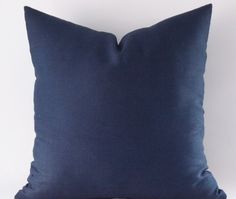 a blue pillow sitting on top of a wooden table