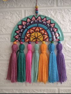 a wall hanging with tassels on it