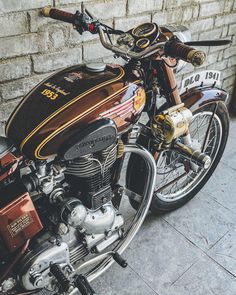 a motorcycle parked next to a brick wall