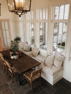 a living room filled with furniture and lots of windows