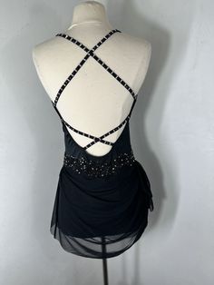 a mannequin wearing a black dress with beading