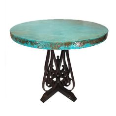 a round table with an iron base and turquoise top